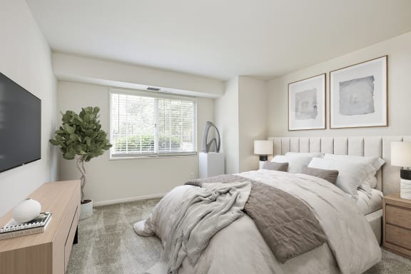 a bedroom with a large bed and a large window at Fairfax Square, Fairfax, Virginia