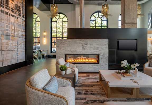 A modern living room with a fireplace and comfortable seating.
