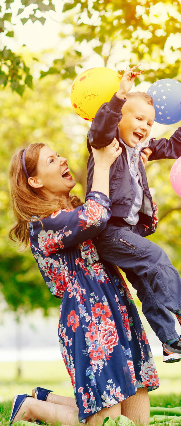 a family playing with balloons in a park