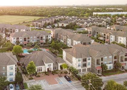 an aerial view of a neighborhood with houses and a swimming pool