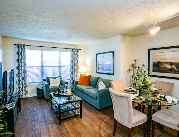 A living room with a couch, chairs, and a coffee table.