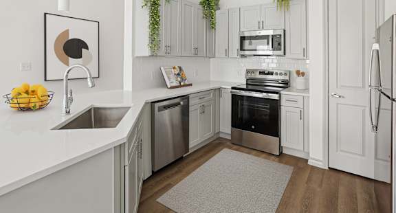 A modern kitchen with stainless steel appliances and white cabinets.