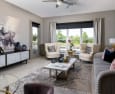 a living room with a large window and a view of a golf course