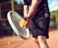 a man holding a tennis racquet and a tennis ball