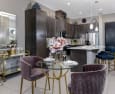 a kitchen and dining area with dark wood cabinets and a marble countertop