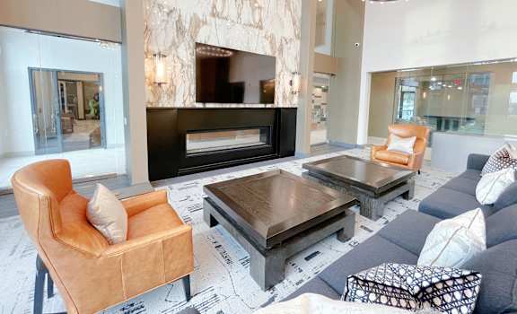 a living room with a blue couch and a fireplace
