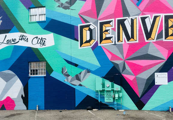 a mural on the side of a building that reads love this city