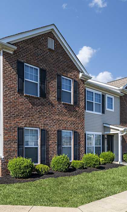 a row of town homes with brick and white siding