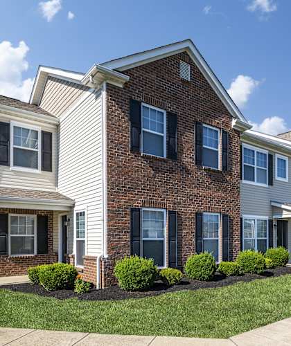 A row of houses with a clear blue sky above them.