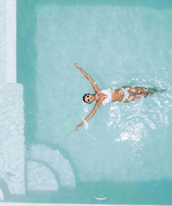 a woman swimming in a swimming pool