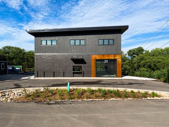 the front of a house with a driveway and a parking lot