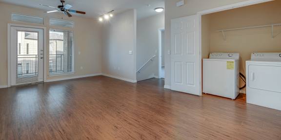 A room with a washer and dryer in it. at Millennium on Post Apartments, Texas