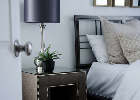 Nightstand with lamp in Bedroom at Pine Ridge Apartments, Rochester Hills, MI, 48307