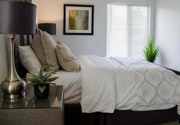 Bright Bedroom with Nightstand at Pine Ridge Apartments, Rochester Hills, MI