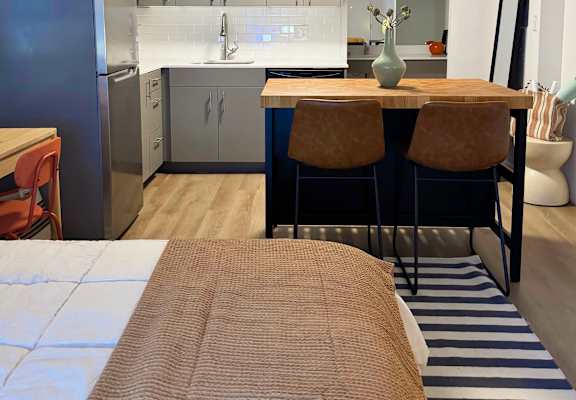 A kitchen with a refrigerator, sink, and cabinets at The Teale Siesta Lago in Kissimmee, FL, 34746
