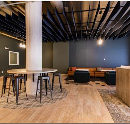 a communal area with a round table and stools