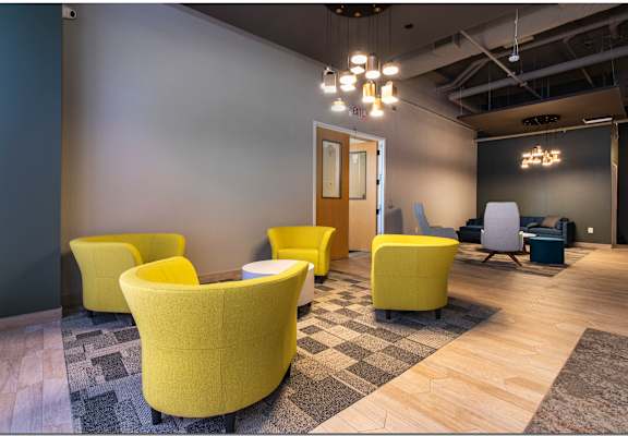a room with yellow chairs and gray walls