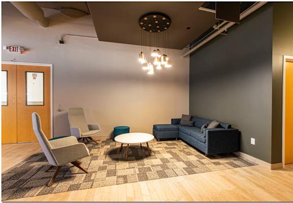a lounge area with couches chairs and a coffee table