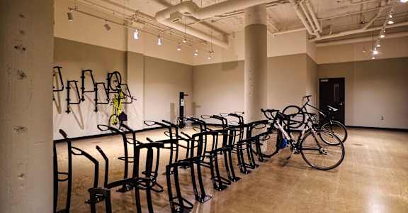 a row of bike racks in a room with bikes on them