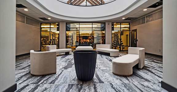 a large lobby with couches and chairs and a table