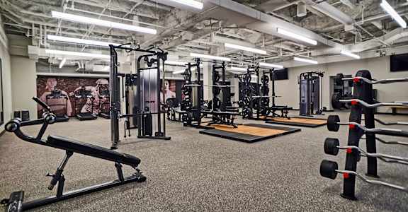 a fitness room with weights and other exercise equipment