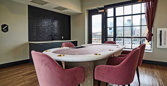 a conference room with a table and chairs in front of a window