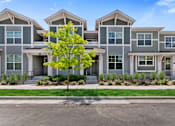 Thumbnail 8 of 8 - an apartment building with a tree in front of it