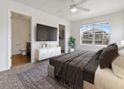 Thumbnail 3 of 8 - a bedroom with a large bed and a ceiling fan
