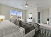 Thumbnail 2 of 8 - a bedroom with a large bed and a ceiling fan
