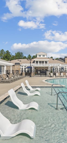 our resort style swimming pool is next to our building with lounge chairs