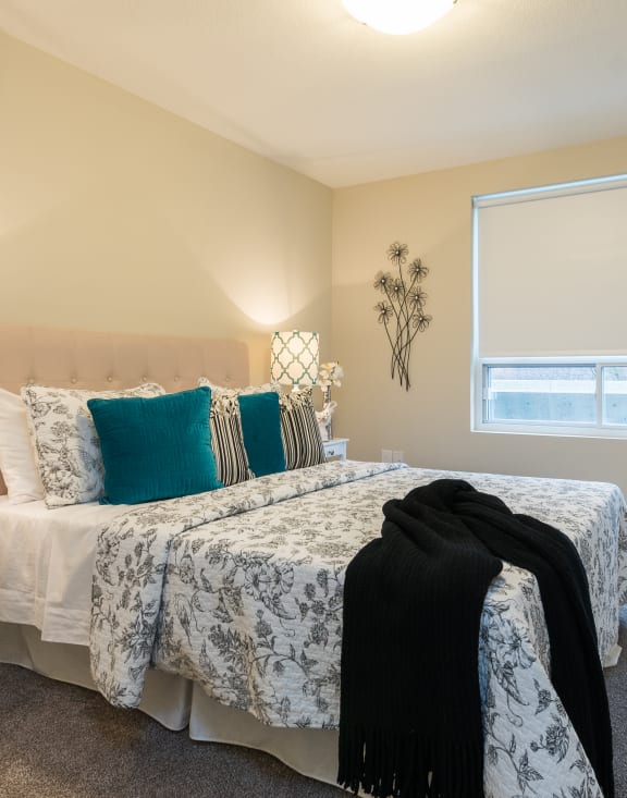 a bedroom with a bed and a window
