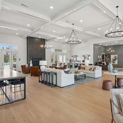 A modern living room with a pool table and a dining table at The Hendry Apartments, Fort Myers, FL, 33905