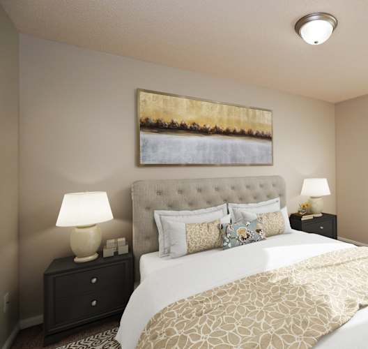 A bedroom with a large bed and a painting on the wall.