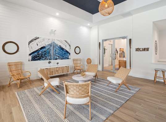 a living room with a couch and chairs and a table