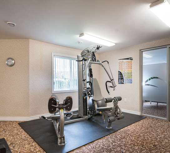 a fitness center with a treadmills and other exercise equipment