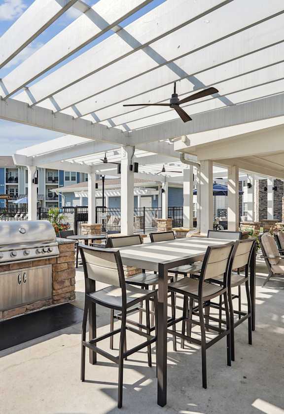 the preserve at ballantyne commons clubhouse with a bar and tables with chairs