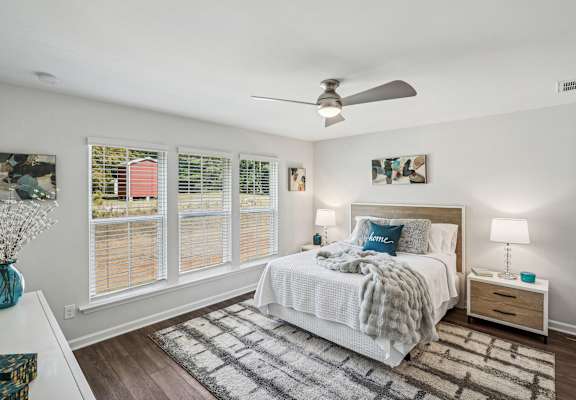 a bedroom with a bed and a ceiling fan