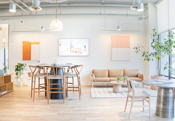 A modern living room with a wooden table and chairs.