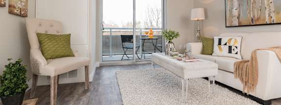 a living room with a sliding glass door that leads to a balcony
