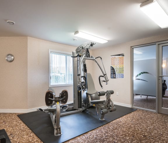 a fitness center with a treadmills and other exercise equipment