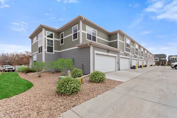 a gray and with a driveway in front of it