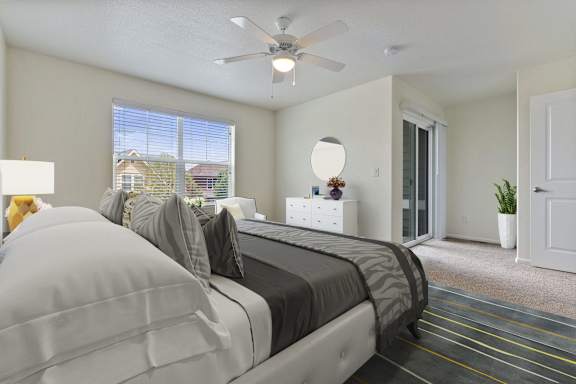 a bedroom with a large bed and a ceiling fan