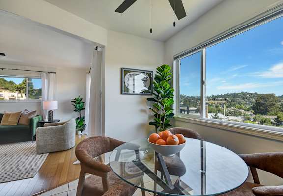 A modern dining room with a glass table and chairs.