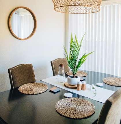 a dining room with a table and chairs and a chandelier