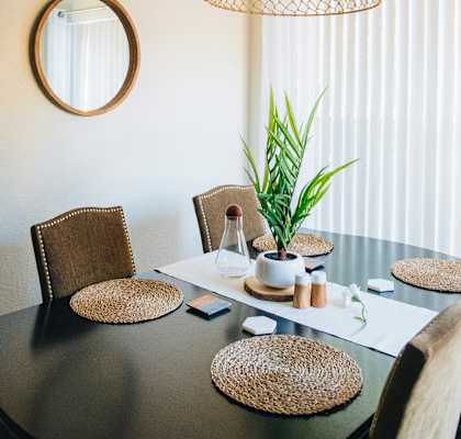 a dining room with a table and chairs and a chandelier