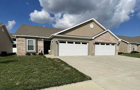 a house with a driveway and a garage door  at Hawthorne Properties in Lafayette, IN 47905