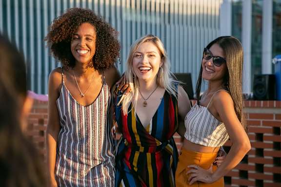 a group of women standing in front of a building