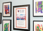 Thumbnail 9 of 17 - A wall with framed artwork including a piece titled "Art from the Heart".