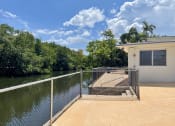 Thumbnail 4 of 18 - the back yard of a house next to a body of water at Lakeside @ Biscayne Gardens,North Miami, FL,33181