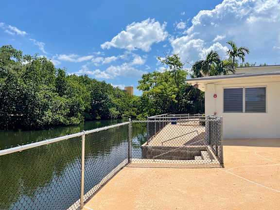 the back yard of a house next to a body of water at Lakeside @ Biscayne Gardens,North Miami, FL,33181